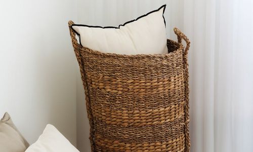 A calm and tidy bedroom with dimmed lights, ready for sleep.